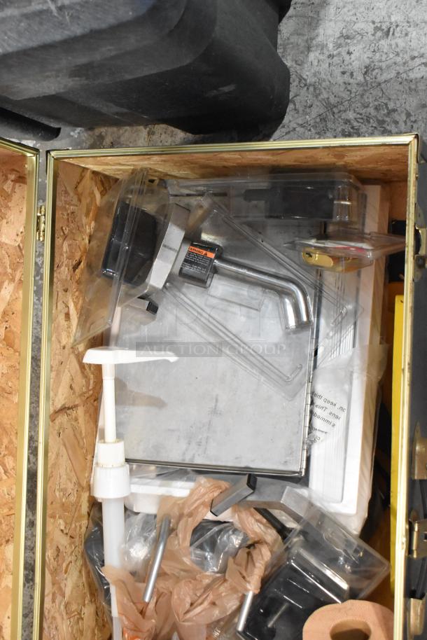 Metal trunk with various hardware contents, including a fire blanket. Trunk's interior visible, items appear organized.