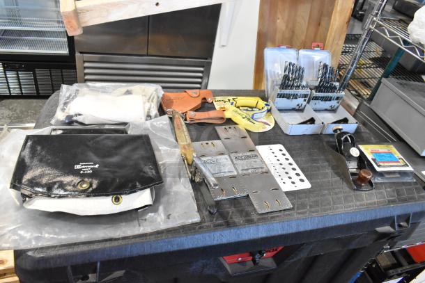 Two bags with contents including trowels and tools; Edmund 8430 bag; new drill bit sets; Accubend rulers.