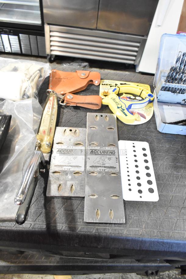 Two various bags containing tools including Estwing branded trowels, Accubend metal plates, a Mega clamp, and drill bits.
