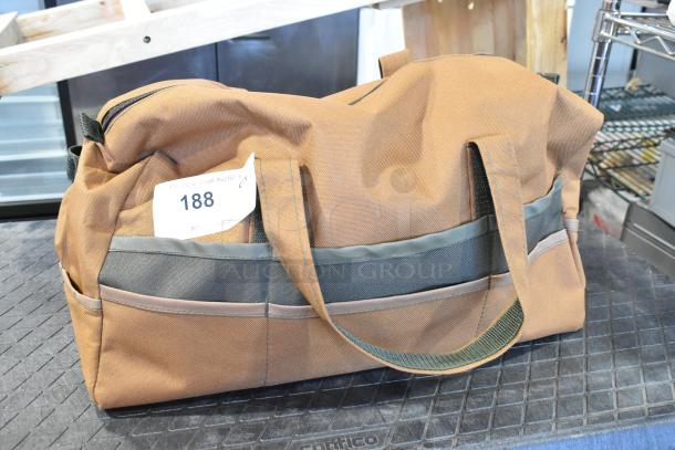 Brown and gray duffel bag with handles, contains trowels. Auction tag 188 visible. Includes two bags with contents.