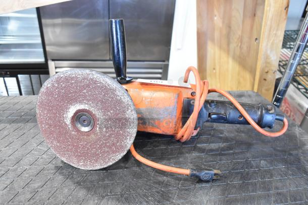 Black & Decker sander/polisher, orange, visible wear, 120 volts, 1 phase, with extended handle and power cord.