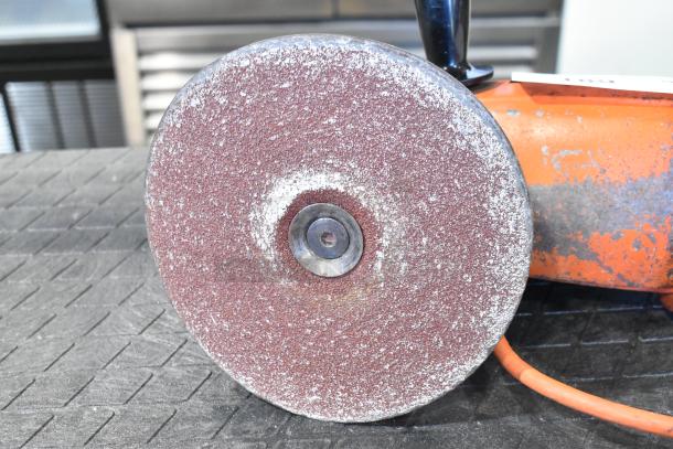 Black & Decker sander/polisher, 120 volts, 1 phase, used condition, visible wear on sanding disc, orange body.