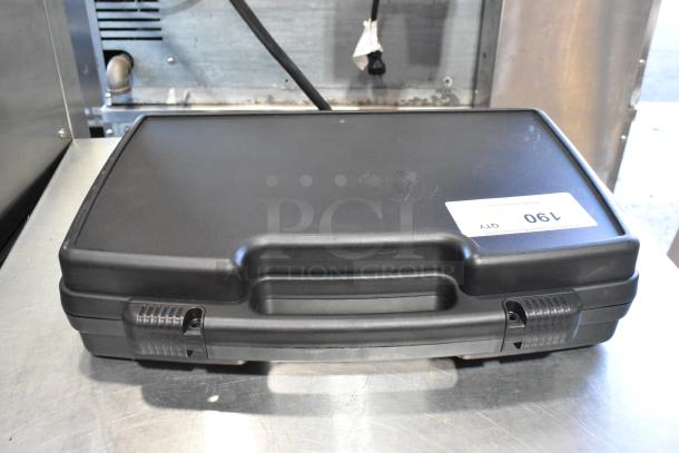 Black hard case with handle, contains tools. Auction label reads "Lot 190." Rugged design, ideal for tool storage.