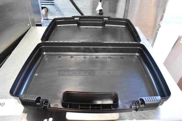 Three black hard cases, open and empty, ready to hold tools. Rugged plastic material, secure latches, good condition.