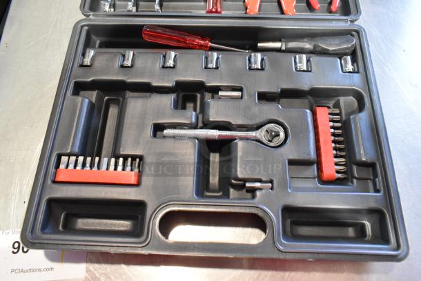 Black hard case with assorted tools, including a red-handled screwdriver, socket set, and ratcheting wrench. Appears in good condition.