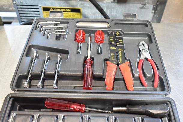 Hard black tool case containing various tools, including red-handled screwdrivers, wire stripper, and pliers.