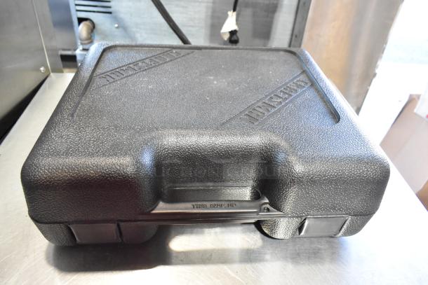 Black hard case featuring textured surface, embossed "Klein Tools" branding, includes contents like tools, in good condition.