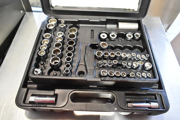 Black tool case with assorted sockets and attachments, various sizes labeled, in good condition, includes sockets and drive extensions.