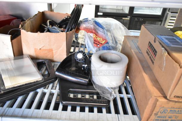 Auction lot with various items: black iron, rolls of tape, cardboard boxes labeled "Murray Circuit Breakers," and poly bins.