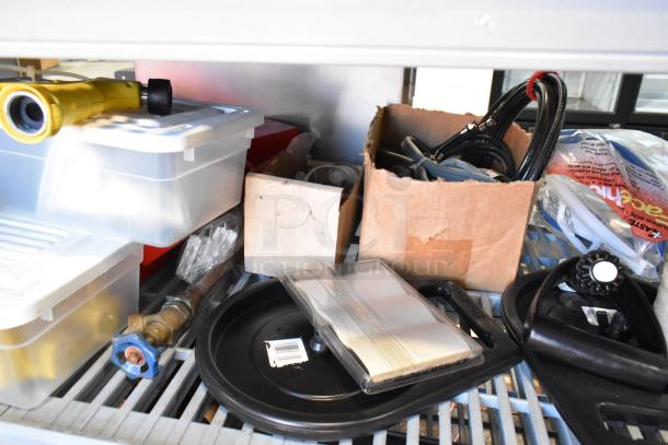 A tiered lot of various items including rope, poly bins, and miscellaneous tools in fair condition, displayed on a shelf.