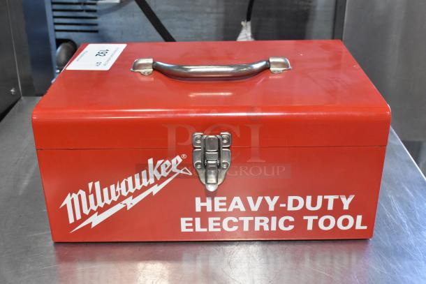 Red Milwaukee metal tool box labeled "Heavy-Duty Electric Tool," containing a Craftsman 3/8 inch electric drill.