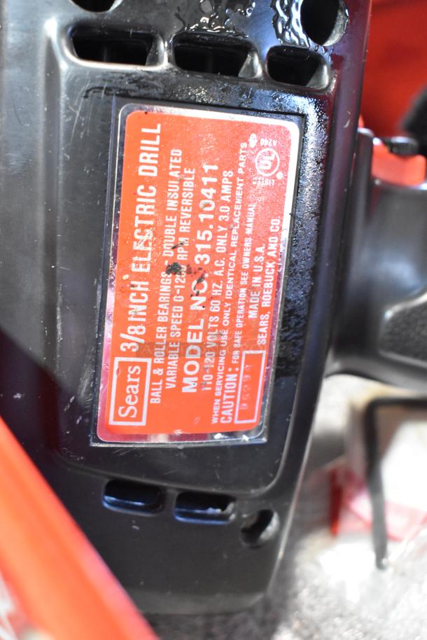 Craftsman 3/8 Inch Electric Drill, model 315.10411, in Milwaukee red metal tool box. Shows clear label with technical specs.