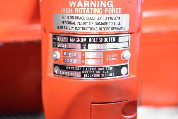 Milwaukee Electric Holeshooter drill, model 0234-1, 1/2" capacity, red, shown with label details. Includes Milwaukee red metal tool box.