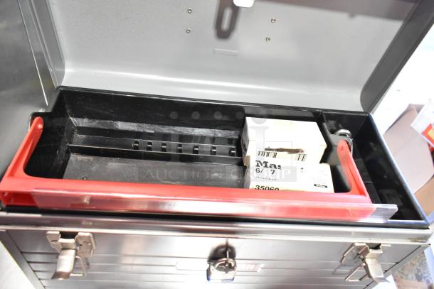 2 metal toolboxes with contents including Skilsaw saw, featuring red interior tray. Labels include "Master Lock."