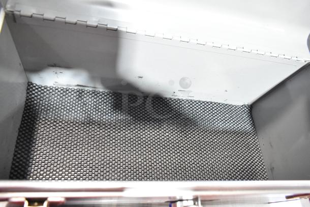 Empty metal toolbox interior with textured lining, showing minimal wear and clean condition. No contents visible.