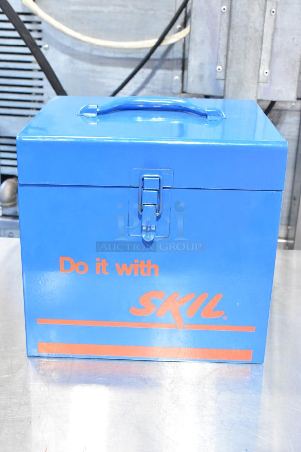 Blue metal toolbox with "Do it with SKIL" text, secure latch, containing Skilsaw saw and more tools. Excellent condition.