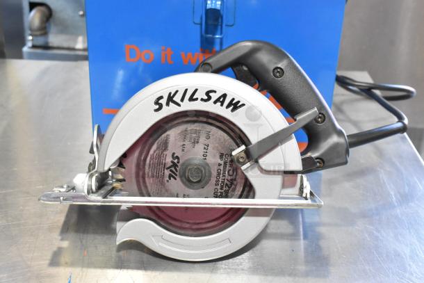 Two metal toolboxes with contents; includes a Skilsaw circular saw. Text on saw blade visible, good condition.