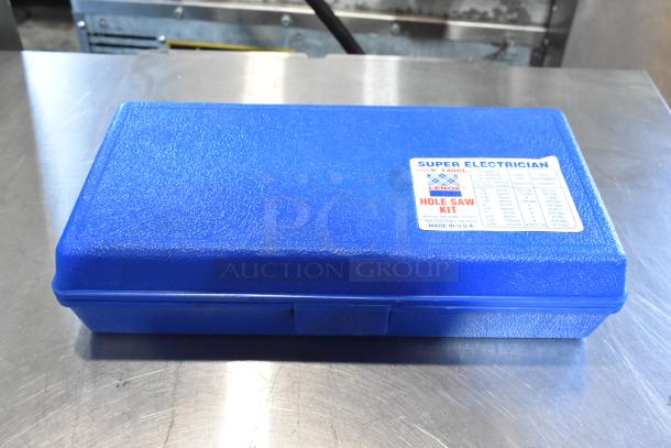 Blue plastic case labeled "Super Electrician Hole Saw Kit, Lenox," made in USA, containing cutting tools.