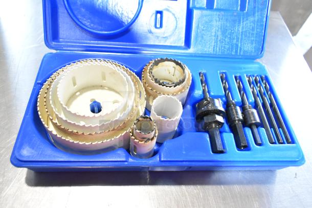 Hole saw kit in blue case with multiple sizes, drill bits, and attachments. Good condition. Part of two poly bin auction lot.