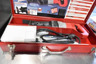 Milwaukee Electric Sawzall in red tool box, excellent condition, features Quik-Lok Blade Clamp, includes power cord and instructions.