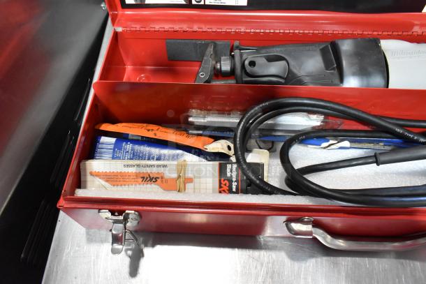 Milwaukee Electric Sawzall in red tool box, includes power cord and extra blades; clean and well-maintained condition.