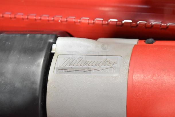Milwaukee Electric Sawzall close-up, showing logo on durable casing in red tool box.