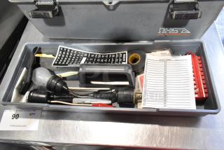 Gray poly tool box with various contents including a Craftsman autoranging multimeter, wiring tools, and a directory label.