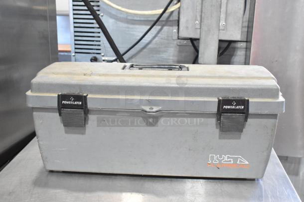 Gray Flambeau poly tool box with PowerLatch locks, containing a Craftsman autoranging multimeter. Slightly dusty exterior.