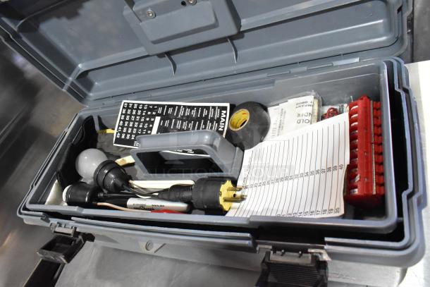 Gray poly tool box with contents including a Craftsman autoranging multimeter, bulbs, plug adapter, labels, and tape.