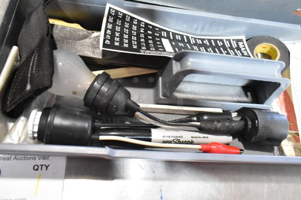 Gray poly tool box with various items including Craftsman autoranging multimeter, light bulb, Sharpie, and electrical tape.