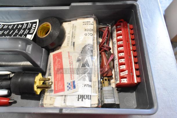 Gray poly tool box with assorted contents, including a Craftsman autoranging multimeter, electrical tape, and connectors.