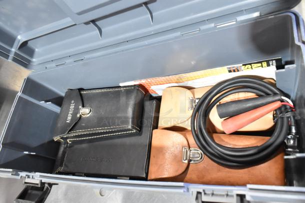 Gray poly tool box containing a Craftsman autoranging multimeter, Amprobe case, cables, and accessories in good condition.