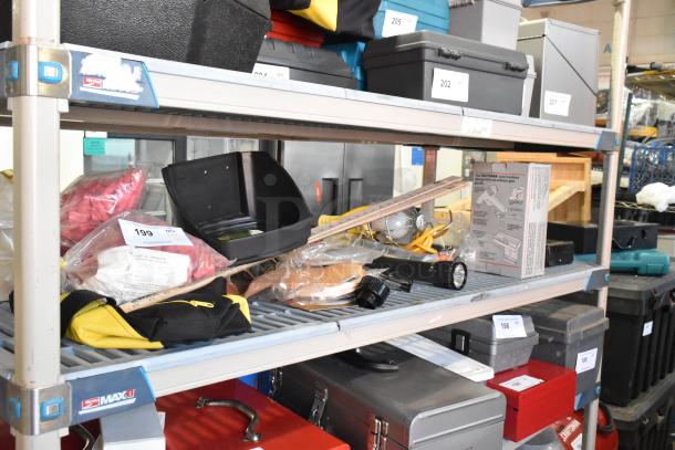 Tiered shelf with assorted items including a glue gun kit, flashlight, worklight, and various tools. Item tags indicate auction lot.