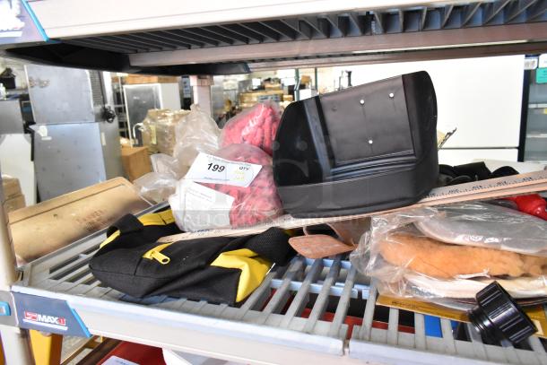 Tiered shelf with assorted items, including a glue gun kit, flashlight, and worklight. Bag with label "199" visible.