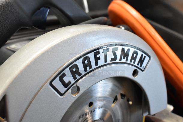 Craftsman 7-1/4" circular saw in tool box, 120 volts, 1 phase, metallic finish, visible branding, in good condition.