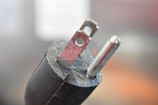Close-up of a Craftsman circular saw power plug, showing a standard two-prong plug suitable for 120 volts.