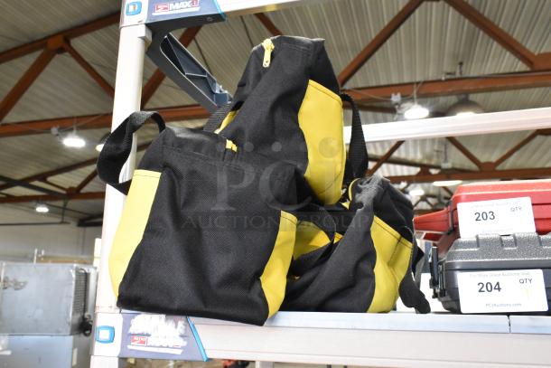 Three black and yellow bags with contents, including a dusting brush and kneepads, stacked on a shelf.