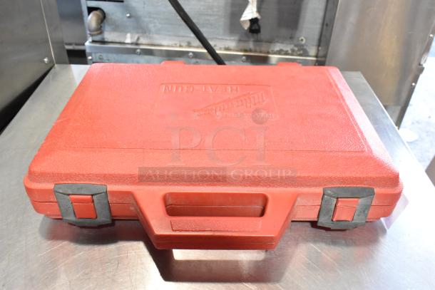 Milwaukee electric heat gun in hard case, 120 volts, 1 phase, red case with handle and latches, embossed brand name.