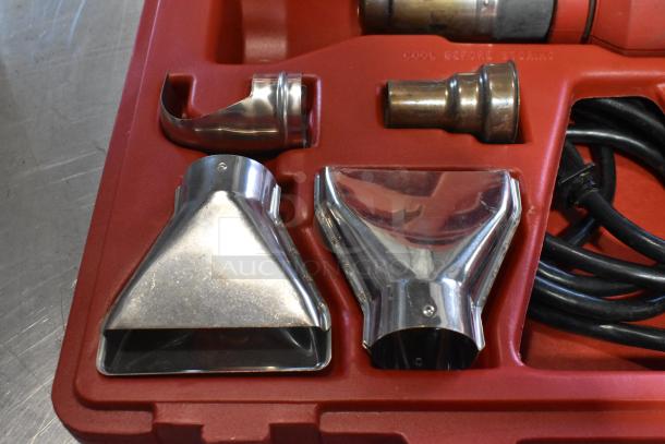 Milwaukee Electric Heat Gun in hard case, includes multiple nozzles and power cord. 120 Volts, 1 Phase. "Cool Before Storing" label.