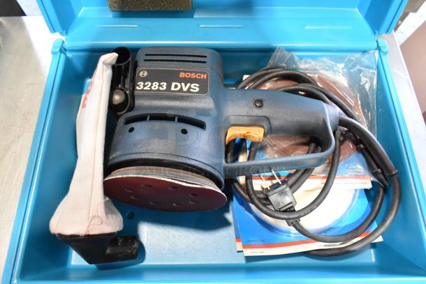 Bosch 3283 DVS Electric Sander in a blue hard case, featuring power cable, with accessories; lightly used condition.
