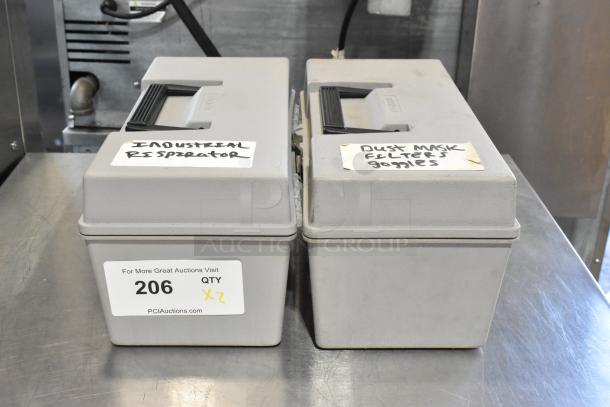 Two gray poly tool boxes with contents, including dustmask and safety goggles. Labels read "Industrial Respirator" and "Dust Mask Filters Goggles." Auction lot 206.
