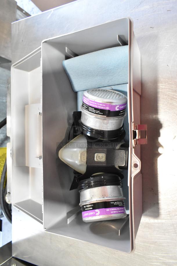 Gray poly tool box with safety goggles, dust mask, and contents. Includes blue cloth. Good condition.