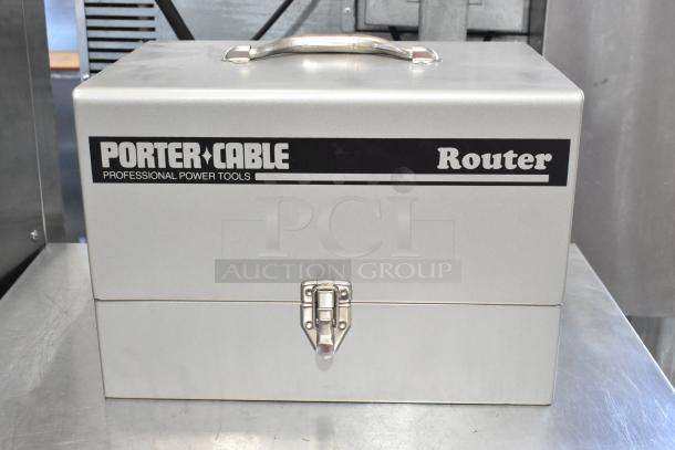 Porter Cable Electric Router in gray tool box, 120 volts, 1 phase, sturdy metal construction, includes secure latch and handle.