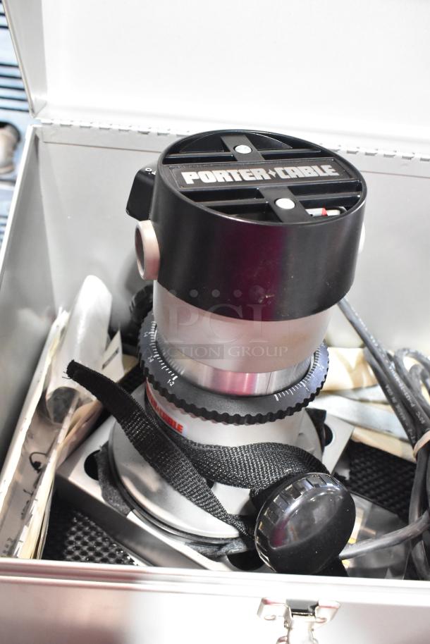 Porter Cable electric router in gray tool box, 120 volts, 1 phase, includes cord and adjustment knob.