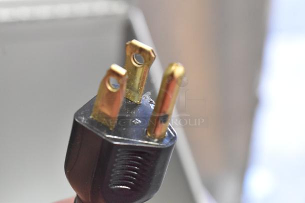 Alt text: Porter Cable electric router power plug showing prongs, close-up view. 120 volts, 1 phase. Part of gray tool box set.