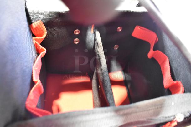 Milwaukee soft tool bag interior, featuring red and black fabric with multiple compartments and durable stitching.
