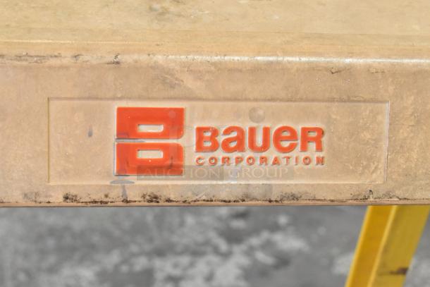 Bauer 300 lb capacity A-frame ladder, yellow with "Bauer Corporation" label. Sturdy construction, used condition.