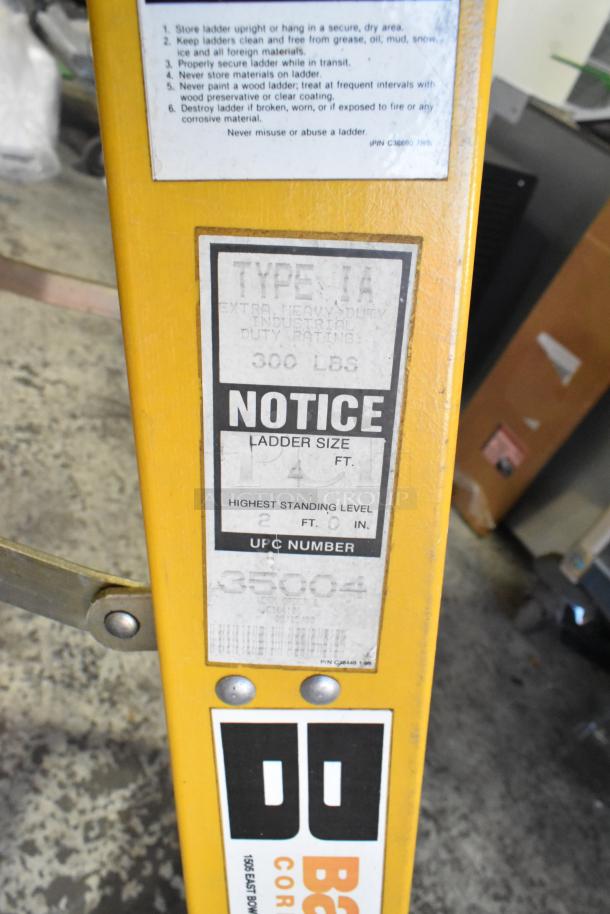 Bauer 4 ft A Frame Ladder, 300 lb capacity, Type 1A, yellow, industrial duty, good condition with usage instructions visible.