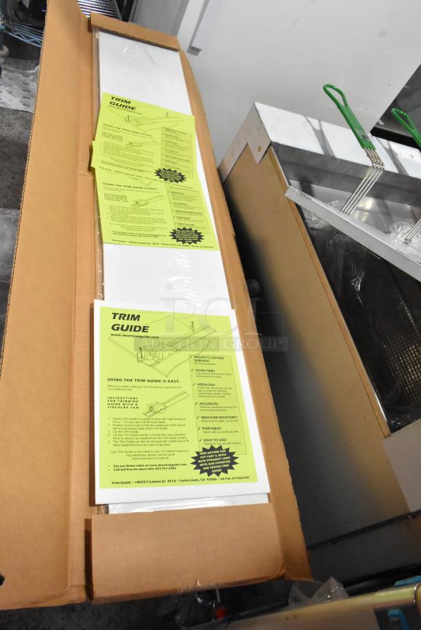 Trim Guide in open box with instructional manuals. Yellow sheets outline usage and features. New condition.