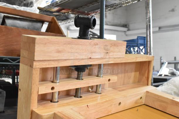 Wooden table with robust construction, visible metal hardware, smooth natural finish, in good condition.